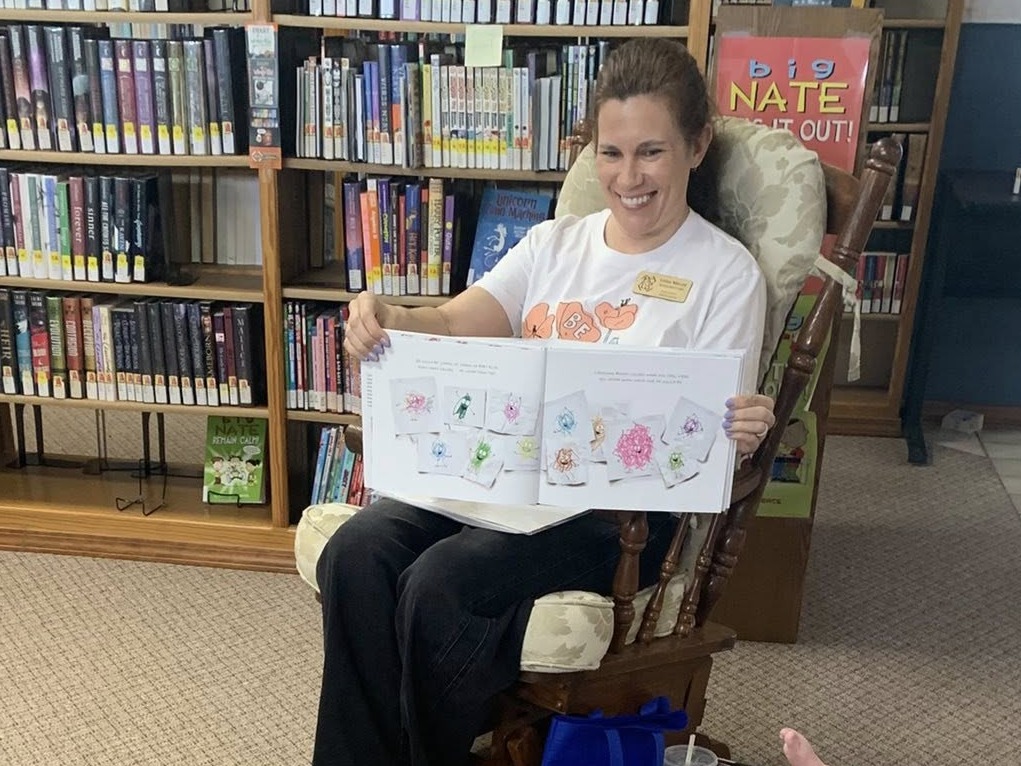 Ms. Lydia with open picture book