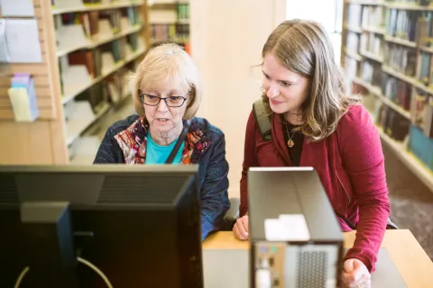 Two women looking at computer screen