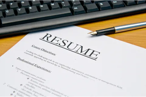 Photo of computer keyboard, pen, and Resume