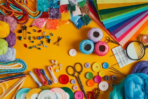 photo of crafting items: scissors, buttons, sequins, thread, and more
