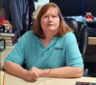 Jane Wilkerson sitting at a desk look toward the camera