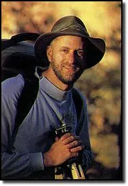 Tim Ernst dressed for hiking with a backpack and cowboy hat