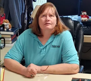 Jane Wilkerson sitting at a desk look toward the camera