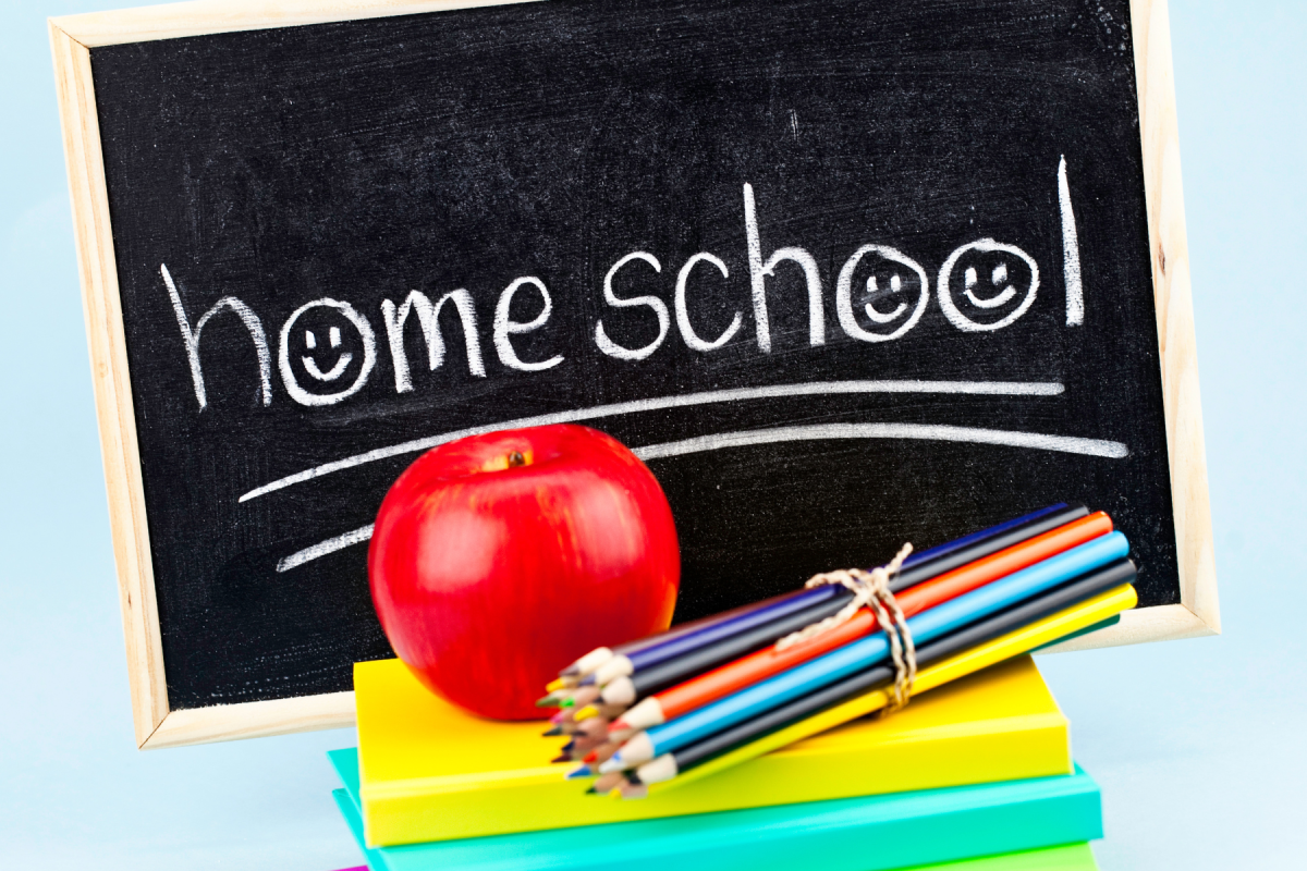 homeschool written on chalkboard plus apple, pencils, and notebooks